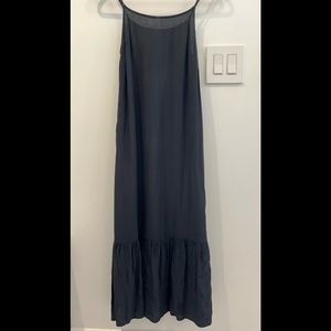 Black sleeveless dress with a ruffle on bottom